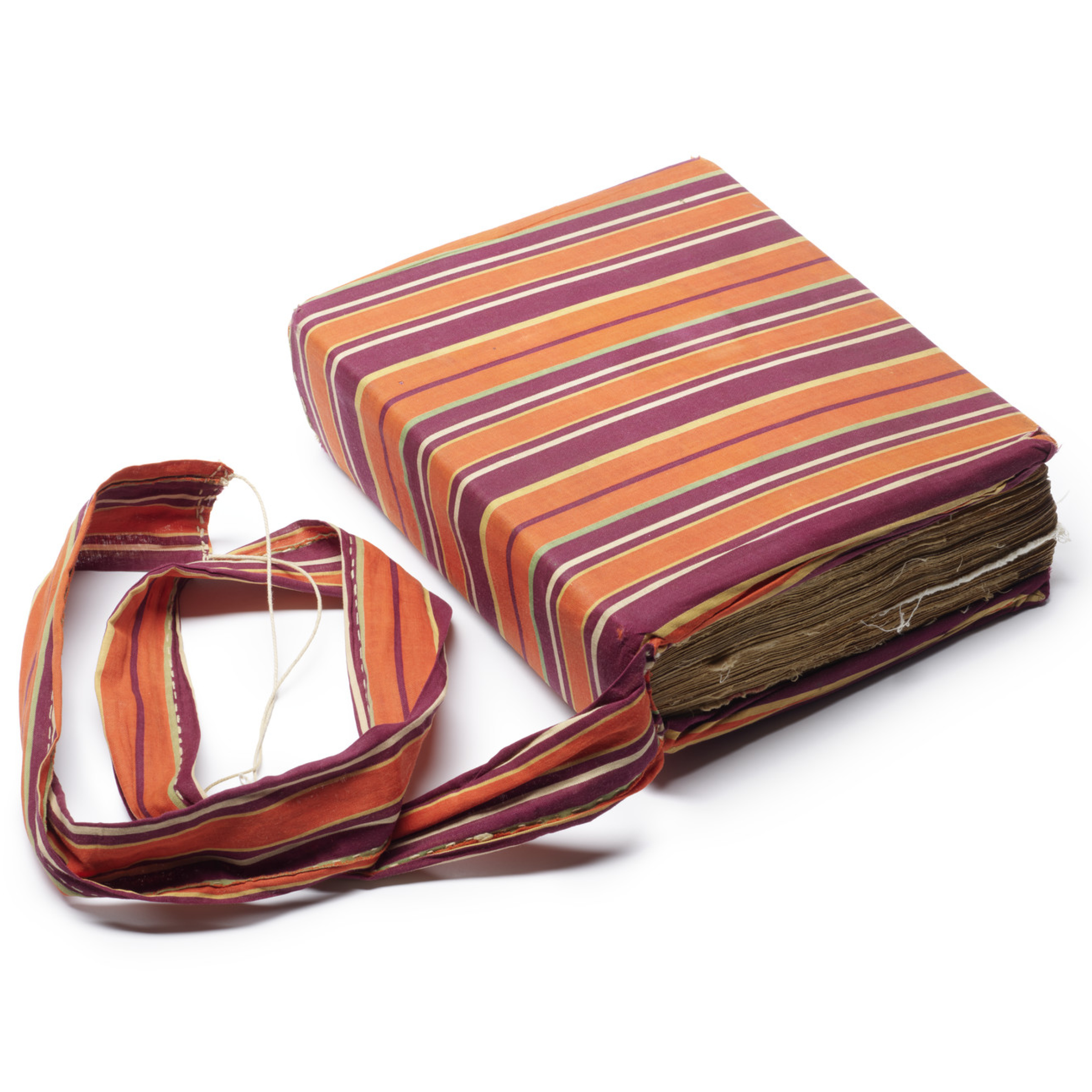 Orange, yellow, green, and ivory striped textile chemise covering the binding of the Gondar Homiliary.